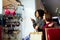 Two happy multiethnic young mixed race woman shopping for lingerie near clothing boutique shop window, decide whether to