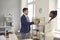 Two happy respectful diverse people shake hands before business meeting in office