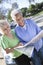 Two Happy Senior Women Reading Map