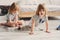 Two happy sibling boys playing together at home with toy cars