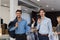 Two Happy Smiling Businessmen Wearing Elegant Suits Standing In Modern Menswear Retail Store