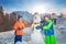 Two happy smiling kids build and dress snowman outside