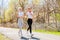 Two happy sporty girls running in the park