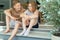 Two happy teenage siblings having fun together sitting on terrace