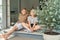 Two happy teenage siblings having fun together sitting on terrace