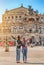 Two happy Women friends hugging and admiring view of Semper Opera Theatre in Dresden