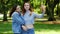 Two happy women make selfie on the mobile phone on the city park