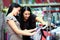 Two happy women shopping in clothes store