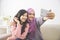 Two happy young muslim woman take self portrait