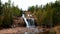 Two Harbors, MN - October 25, 2018: Young couple exploring Gooseberry Falls State Park in Minnesota.