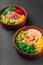 Two hawaiian poke bowls with tuna fish and shrimp