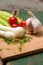 Two heads of spring onion on chopping board