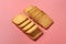 Two heaps of whole square cookies lies on pink desk on kitchen