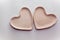Two heart plates made of fireclay on a white background. Creation of ceramics. Bisquit firing ceramics