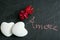 Two heart-shaped pebbles with inscription of love