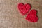 Two Hearts on burlap Background. Wedding Love Concept