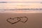 Two hearts drawn in beach