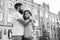 Two hearts full of love. Sensual couple in love with building on background. Bearded man hugging adorable woman with