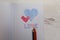 Two hearts hand drawn the word love on graph paper three coloring pencils