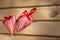 Two hearts sewn from red plaid fabric on the board