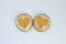 Two hearts shaped golden ginger cookies with flour.