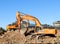 Two heavy excavators at work  during urban redevelopment works.