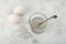Two hen\\\'s eggs and Water soluble Xanthan gum in glass on the table. Xanthan gum