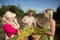 Two herbalists standing in a field meadow met a man with a garland on his head. Field herbs of goldenrod.