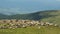 Two herdmen driving a herd of sheep down the mountain pasture. Landscape of Carpathians mountains. Extreme long shot