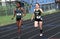 Two high school girls participate in a track meet