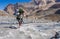 Two hikers crossing mountain river