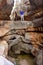 Two hikers stand on natural bridge