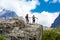 Two hikers staying on rock