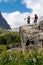 Two hikers staying on rock