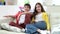 Two Hispanic Children Sitting On Sofa Watching TV Together