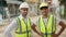 Two hispanic men architects smiling confident standing at street