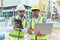 Two hispanic men architects using touchpad and laptop working at street