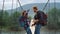 Two hitchhikers enjoy jump on mountains river bridge. Happy couple dance outdoor