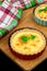 Two homemade quiche with chicken, cheese, cream, onion and mint on wooden background. Above.