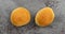 Two homemade yeast rolls on a gray background top view