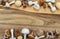 Two horizontal borders with different tiny mushrooms on wooden background.