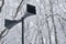 Two horns of a black outdoor loudspeaker in a retro style on the background of a snowy park