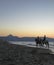 Two horse riders in the beach at dusk