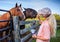 Two Horses at Fence with Woman