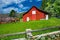 Two horses and a old red barn landscape.