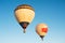 Two hot air balloons in clear blue sky. Aerostat over the field landscape. Close up