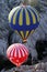 Two hot air balloons float down a valley near Goreme in the Cappadocia region of Turkey.