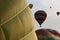 Two hot air balloons inflate side-by-side as four more fly in the background