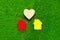 Two houses, a heart on the background of artificial green grass