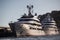 Two huge yachts are in port of Monaco at sunset, sun reflection are on glossy boards of motor boats, the chrome plated